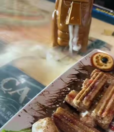 Churros with chocolate sauce on a serving board